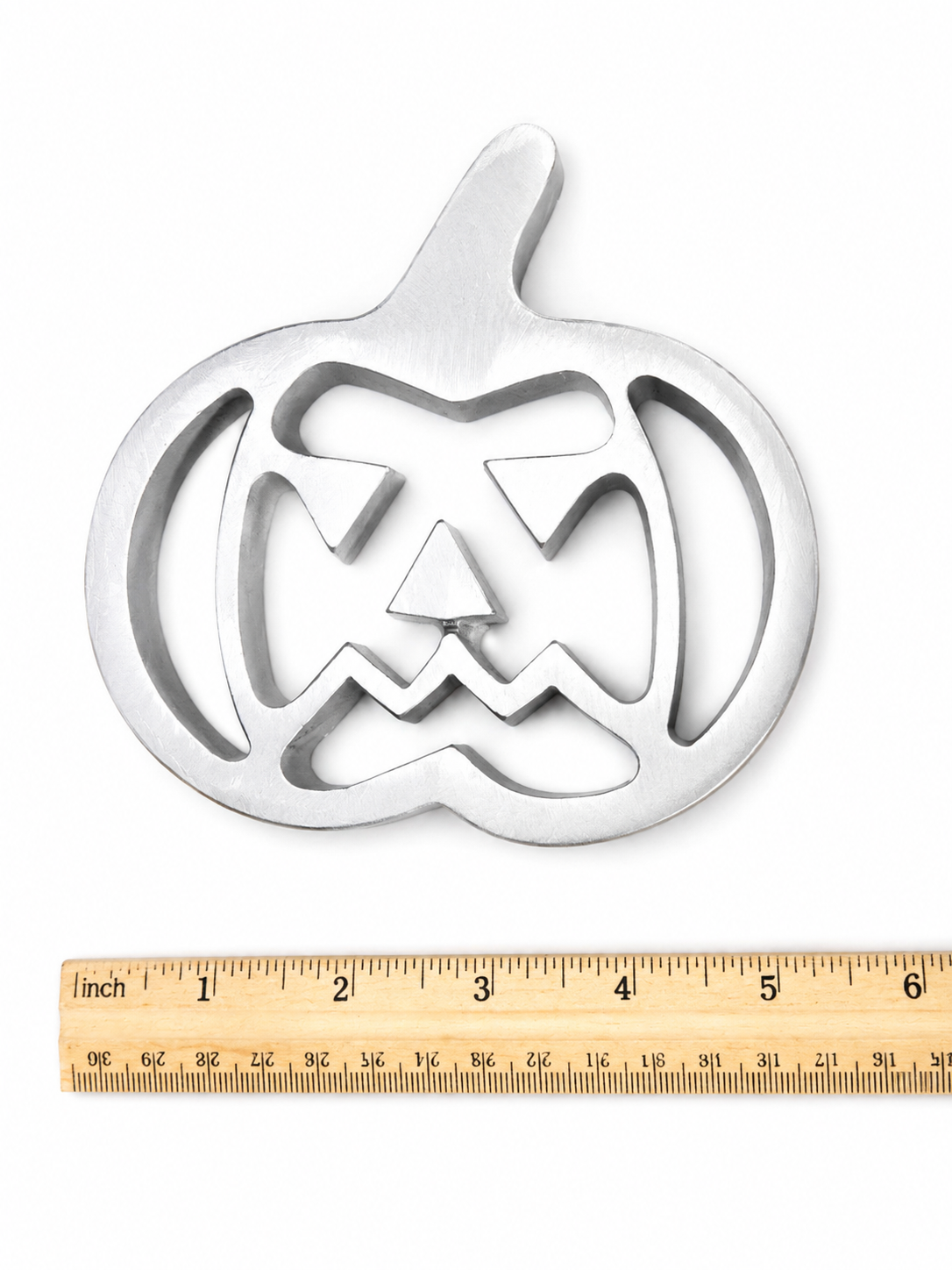 Pumpkin-shaped metal buñuelo mold for making festive fall buñuelos de viento.