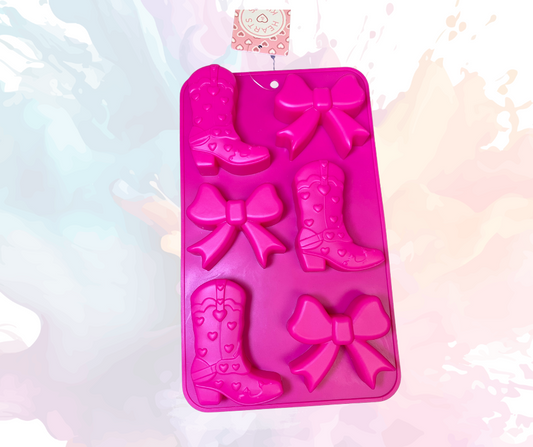 Create delightful treats with this pink silicone mold featuring six cavities for boots and bows, each approximately 2 inches in size. Perfect for baking, chocolate making, and candy crafting. Made from flexible, food-grade silicone. Dishwasher safe and non-stick.